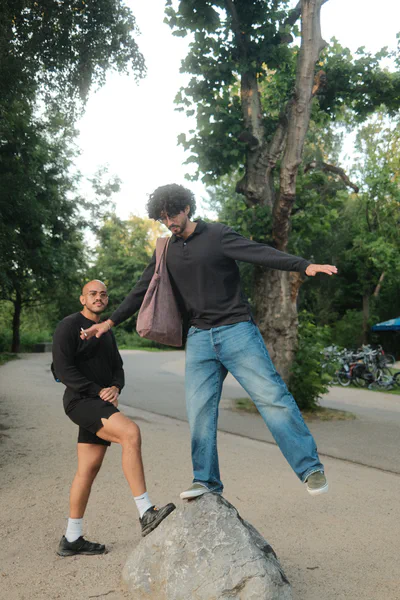 Person balancing on rock in park